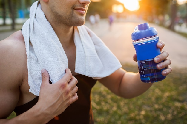 Tired man water tonus hardwork workout concept. refreshing drink after grueling exercises