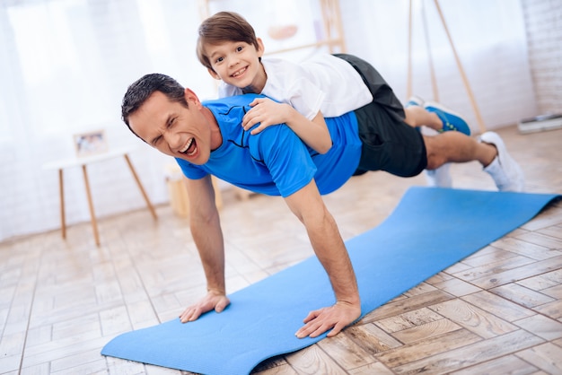 Tired Man with Child on Back Wrung Out from Floor.