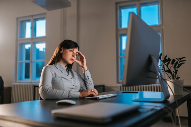 Tired woman working late.