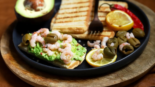 Toast with avocado paste and grilled shrimp