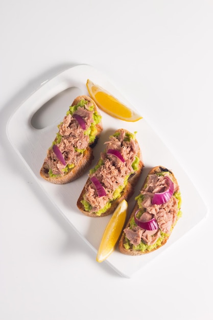 Toast with Canned Tuna Fish open sandwich with red onion and lemon