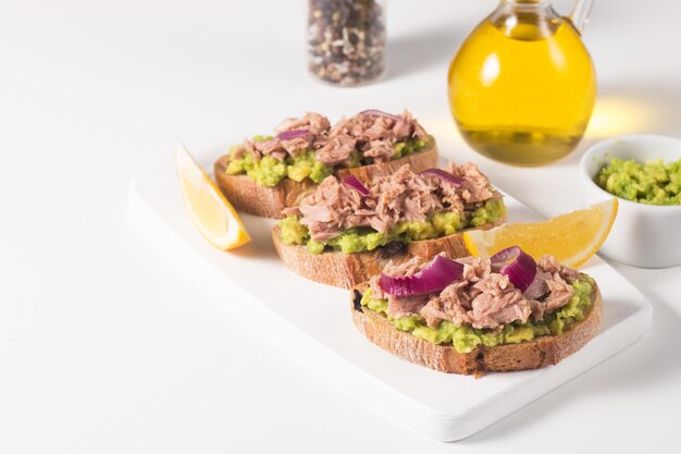 Toast with Canned Tuna Fish open sandwich with red onion and lemon