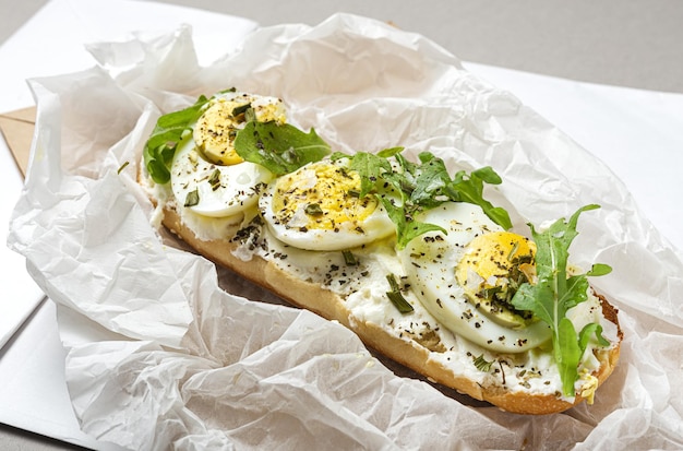 Toast with cream cheese arugula salad and boiled egg