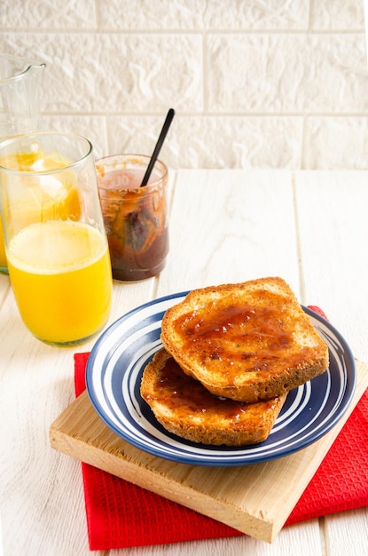 Toast with jam and orange juice White background