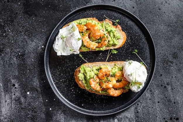 Toast with shrimp prawns avocado and poached egg