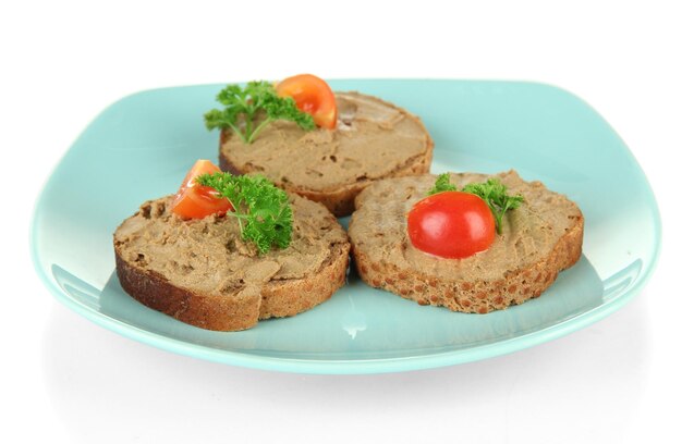 Toasted bread with pate on color plate isolated on white