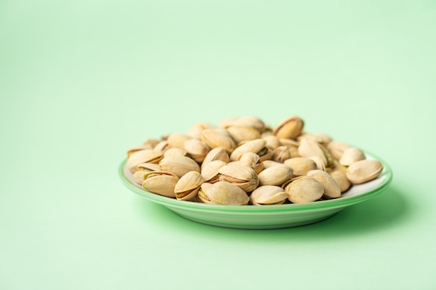 Toasted pistachios over green