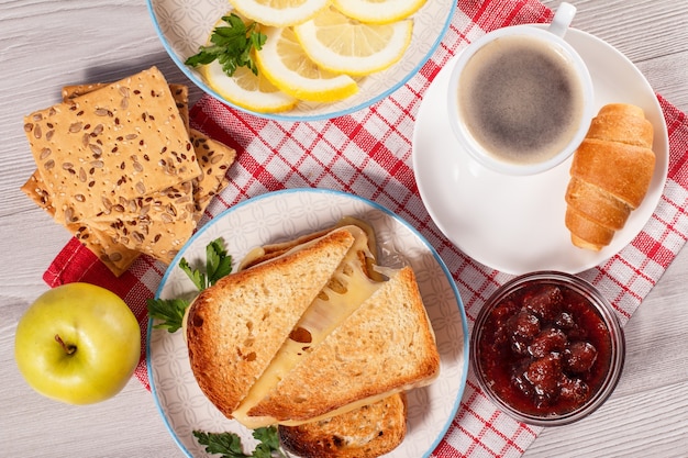 toasted slices of bread with cheese apple cookies with whole grains of sunflower seeds cut lemon