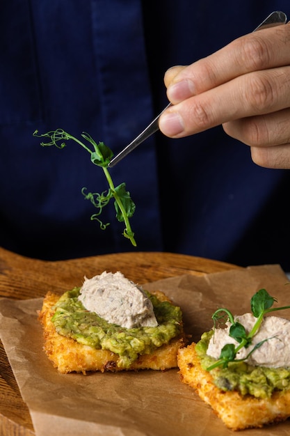 Toasts of dark bread with avocado slices healthy toasts with avocado and Caviar Roe background