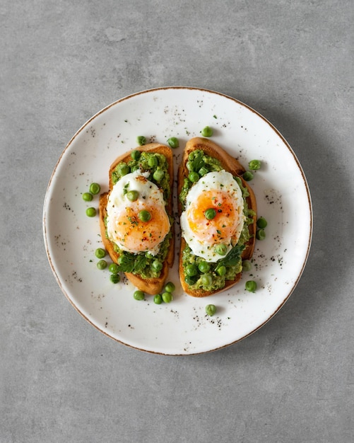 Toasts with green peas and eggs on a concrete background Homemade healthy pea toast