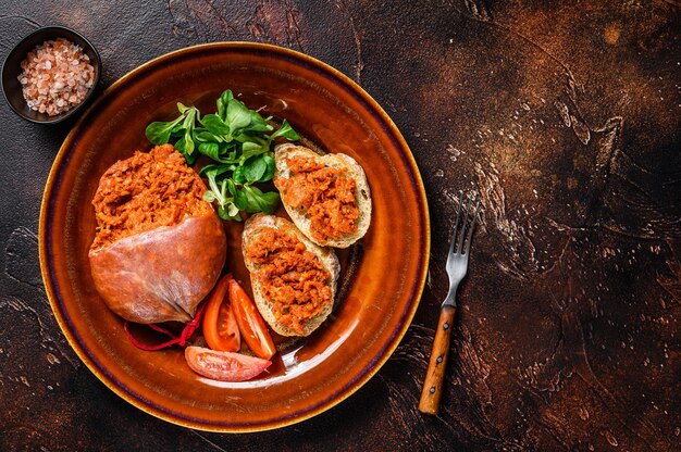 Toasts with Sobrassada cured pork meat sausage and tomato