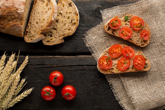 Toasts with tomatoes and bread on a board 