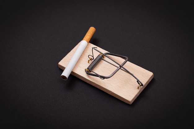 Tobacco addiction  cigarettes in wooden mousetrap