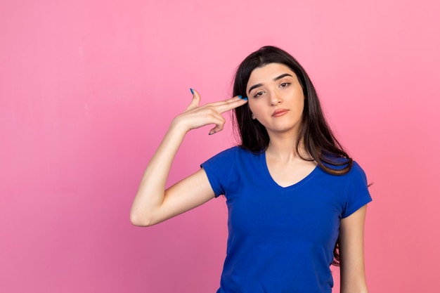 Todd young woman Point her hand as a gun to her head High quality photo