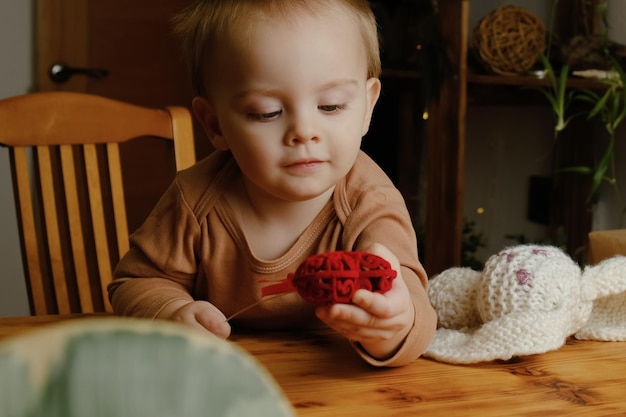 Toddler boy with heart shaped decoration at home