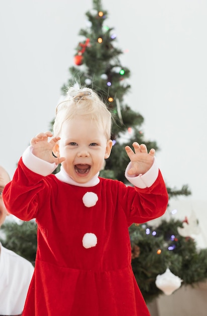 Toddler child with cochlear implant plays near christmas tree deafness and innovating medical technologies for hearing aid and diversity