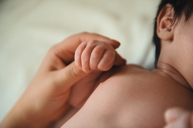 Toddler's hand in mother's hand