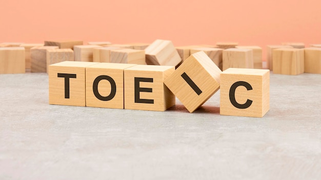 TOEIC word written on wood block text on wooden table for your desing concept