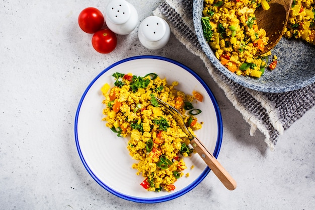 Tofu scramble with vegetables in a white plate