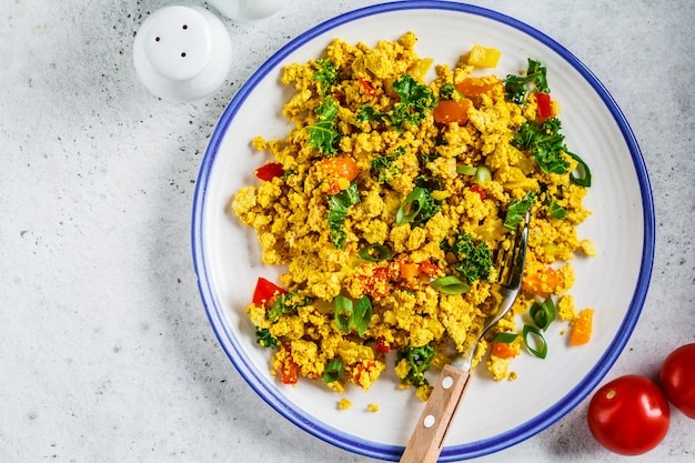 Tofu scramble with vegetables in a white plate