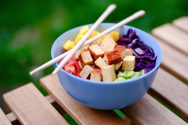 Tofu vegetarian poke bowl on wooden table