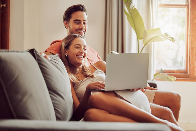 Together is the best place to be. Shot of a young couple using a laptop together at home.