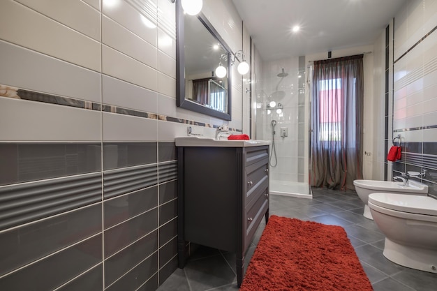 Toilet and detail of a corner shower cabin with wall mount shower attachment