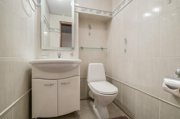 Toilet and detail of a corner shower cabin with wall mount shower attachment