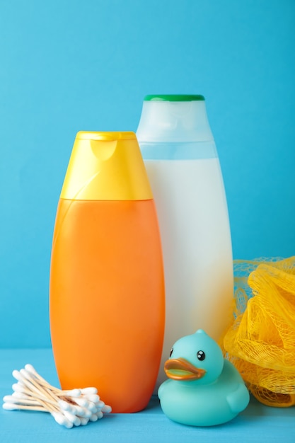 Toiletries baby on blue wall. Baby shower gel. 