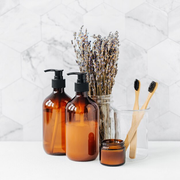 Toiletry Set with lavender. Soap and shampoo bottles on white table in bathroom background.