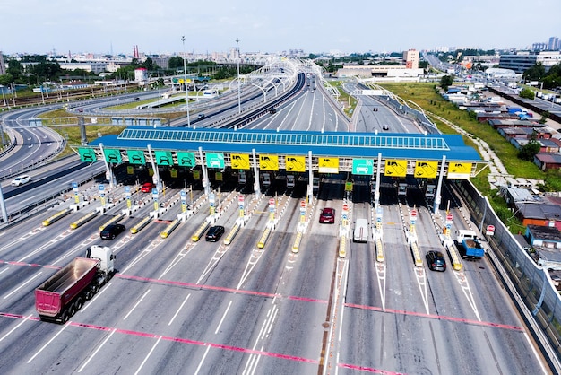 Toll roads on the broad highway Through the point passes a large number of trucks and cars Top down view of a quadcopter