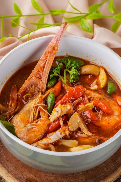 Tom yum or tom yam is a type of hot and sour Thai soup usually cooked with shrimp prawn