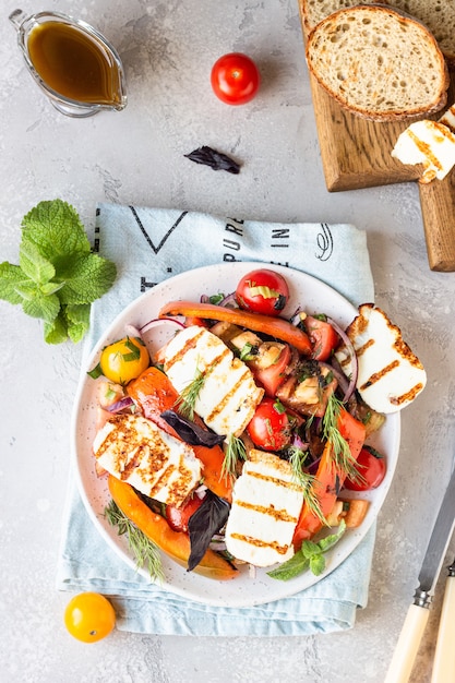 Tomato, baked pepper and onion salad with grilled cheese 