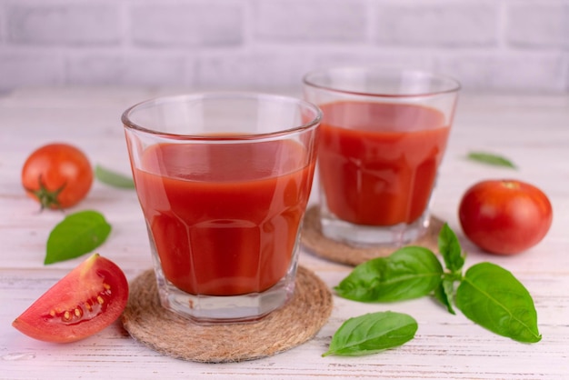 Tomato juice decorated with basil leaves.