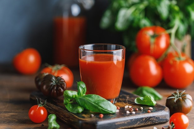 Tomato juice and fresh tomato with basil