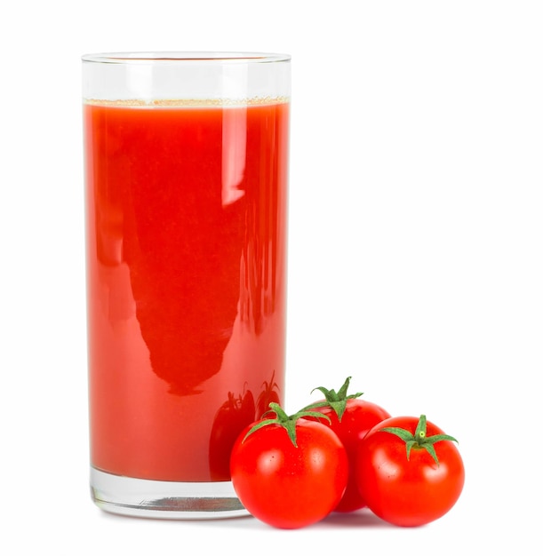 Tomato juice in glass and fresh tomatoes .