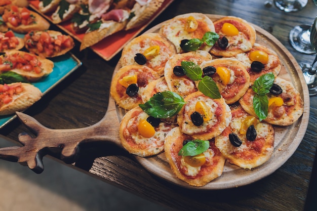 Tomato and mozzarella mini pizzas on board