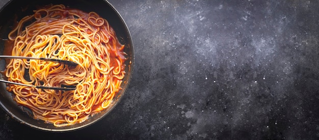 Tomato pasta is cooked in a frying pan