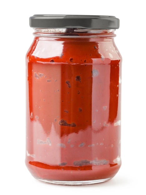 Tomato paste in a glass jar on a white background Isolated