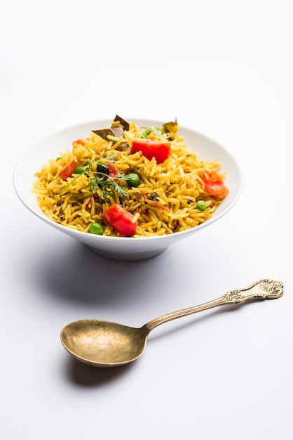 Tomato Rice also known as Tamatar Pilaf or pulav made using basmati rice, served in a bowl. selective focus