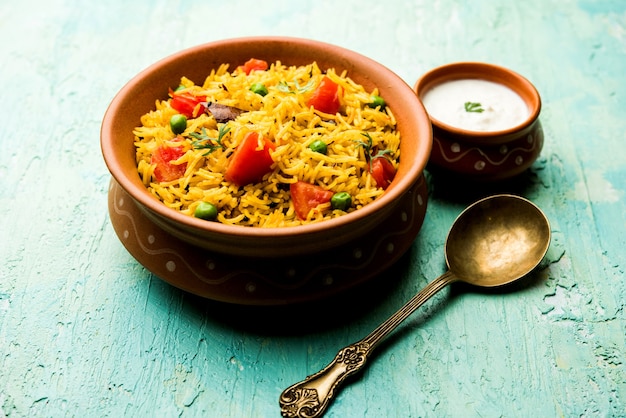 Tomato Rice also known as Tamatar Pilaf or pulav made using basmati rice, served in a bowl. selective focus