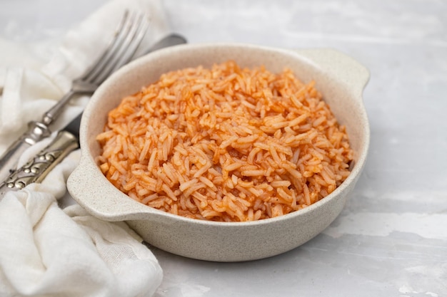 Tomato rice on the dish on ceramic background