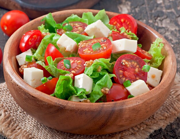 Tomato salad with lettuce, cheese and mustard and garlic dressing