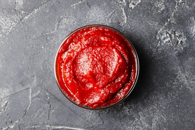 Tomato sauce in a bowl on a dark background