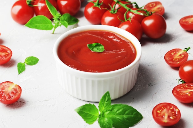 Tomato sauce in a bowl Fresh basil and fresh cherry tomatoes Ingredients for the sauce Ingredients for cooking