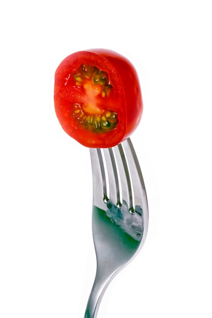 Tomato slice skewered on fork 