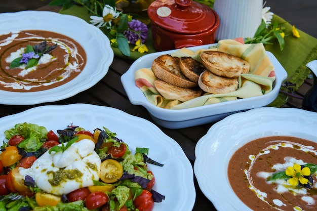 Tomato soup or gazpacho at black table Summer cold vegan food