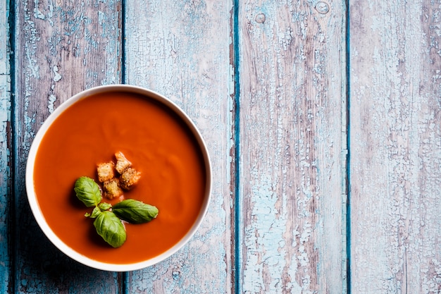 Tomato soup with basil in a bowl