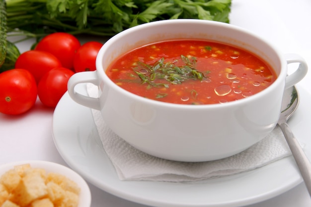 Tomato soup with crackers and herbs