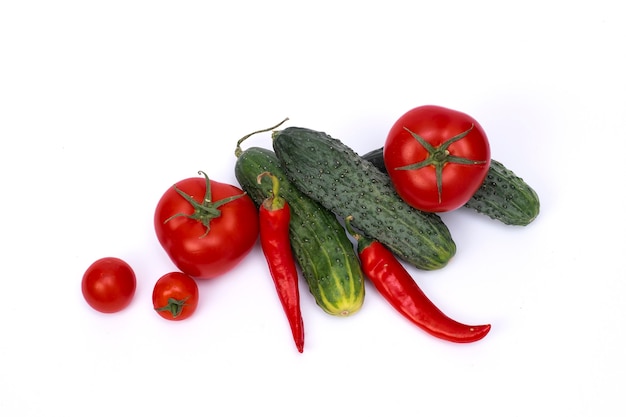 Tomato with cucumber on white background with clipping path. Ripe vegetables isolated on white background.